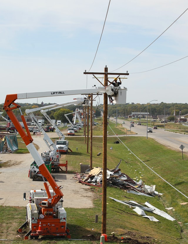 bucket trucks working on power line