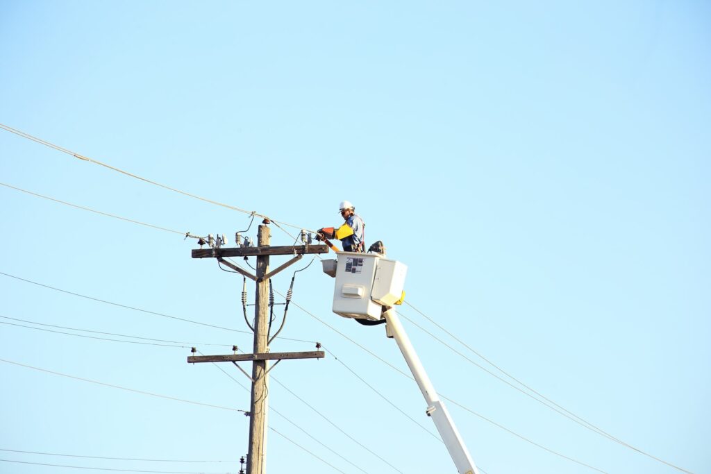 man on the boom working on power line