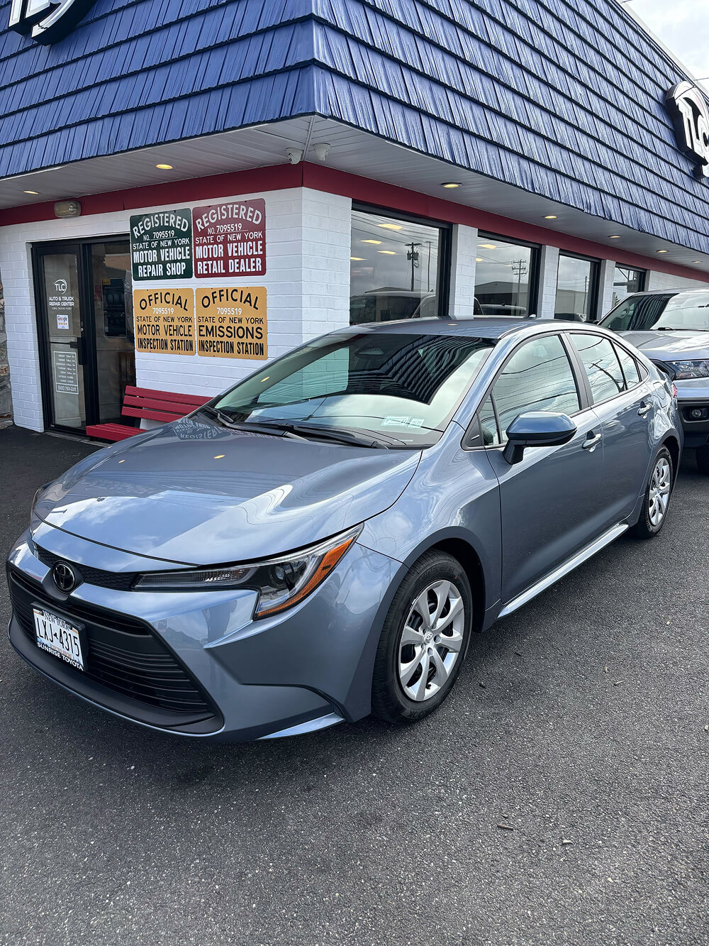 Free loaner Toyota Corolla parked outside TLC Auto & Truck Center in Farmingdale, NY